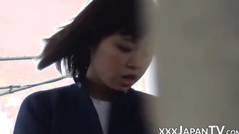Cute Japanese lady moves her panties to masturbate in public