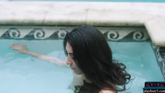 Petite latina MILF dips naked in a pool