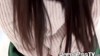 Asian cutie lifts her skirt up to show how she pees