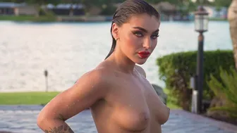 Glamorous naked babe posing by the pool