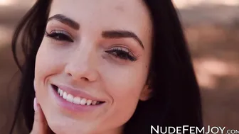 Nubile is spreading her shaved pussy while in the forest