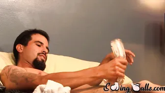 Tattooed gay tickles his big balls and stroking his big cock