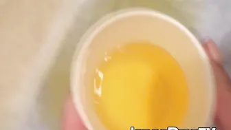 Japanese cutie fills a cup up with her pee and records it