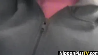 Delightful Japanese chick sits on the latrine and pees in a cup
