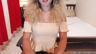 Asain blonde TS wanks cock in chair in front of webcam
