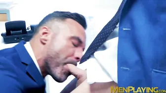 Muscular executive in a suit stuffing his cute buff employee