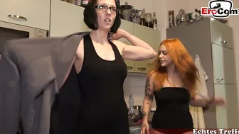Redhead giving blowjob in front of nylon woman with glasses