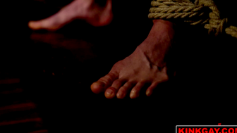 Ethan is on his stomach bound tight with rope