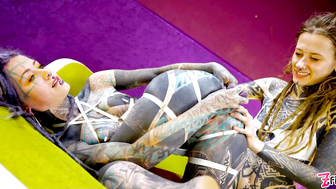 Tattooed hotties fuck each other with crazy toys