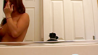 Busty gal shaving her pubes in the shower