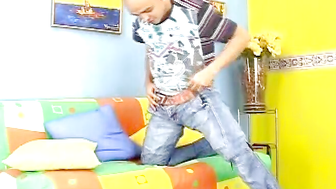 Kinky skinhead latino Cristobal is on the sofa wanking dick