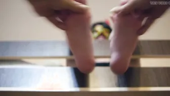 A Man massages adorable Female legs vigorously to the Music