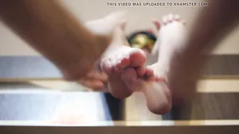 A Man massages adorable Female legs vigorously to the Music