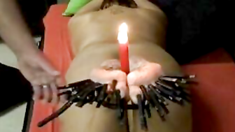 Tormenting feet with clamps, cane and wax