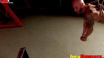 Drake Jaden is suspended in a hogtie pose while getting electrified by Preston Steel