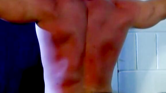 Muscled Derek Pain takes flogging all over his sexy back til it is rosy red