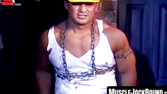MuscleJockBound.com - Bound by chains, tattooed man in uniform endures rough and erot