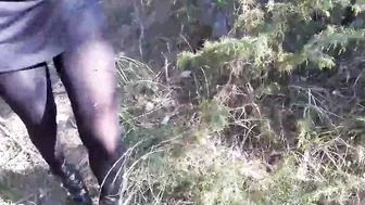 Walking on the wood wearing a ebony dress stockings heels
