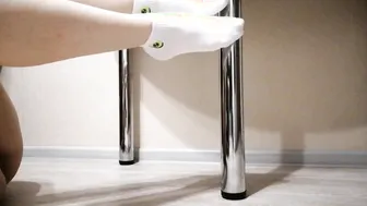 My Legs inside White Socks Gently Caress the Table Leg.