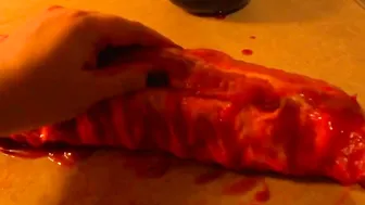 Rubbing the pig like he is a piece of meat