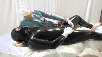 The rubber doctor is having fun with the patients cock two