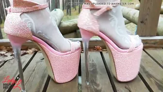Lady L walking inside tower pink intense high heels.