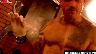 Muscular hunk endures bondage with pins in his chest