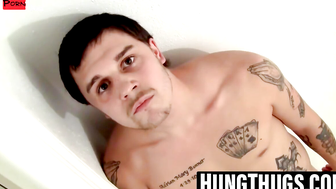 Tattooed dude shows off his thick cock while stroking slow