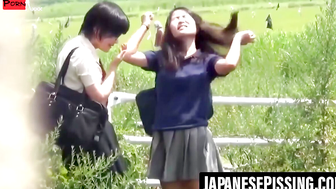 Voyeurs cam catches two Asian ladies firing long piss streams