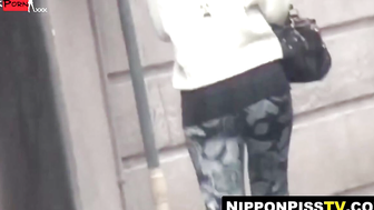 Peeping lens films girls urinating in open public toilets