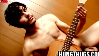 Handsome guy plays guitar while jerking off alone