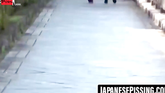 Japanese lady lets piss flow out while still in a skirt