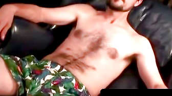 Hairy dude whips out his dick on the couch and cums