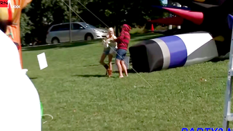 Blonde in Green Top Gets Spanked at Outdoor Giant Inflatables Party