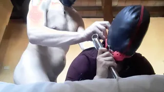 Bound to a machine masked hooded and throated