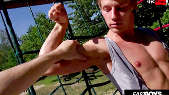 Muscular blond twink workouts on playground pull-up bars and shows his dick