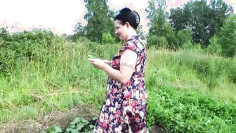 Big Boobed MILF masturbates with cucumber and strawberries outdoor into a outside place