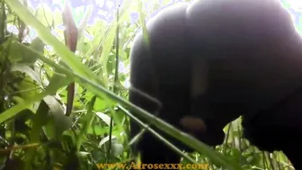 Native Black sex toy masturbating inside the jungle