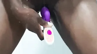 African masturbating inside the shower with dildo