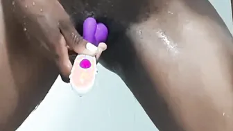 African masturbating inside the shower with dildo