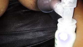Black pumping milk out of her long hooters and nipples