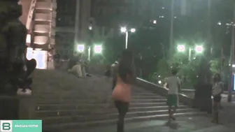 Dark Haired lifting the dress into outdoor into the middle of the citys traffic. ( Full