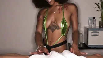 Tattooed black masseuse wanking penis during naughty rubs