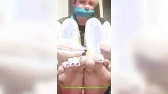 Gagged she ties her foot with green string and stretches wiggles and flexes until they break free