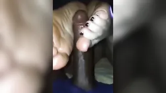 Rubbing big black dick with my little feet