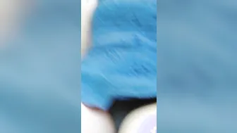 Smoking into outdoor up skirt while rolling blunt.