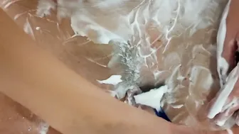 Alice inside the toilet lathers her vagina with foam then shaves leaving a strip of hair on her pubis