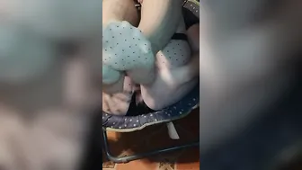 Points foot and spreads legs inside stockings