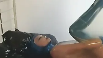 beauty women With Blue Pvc Mask And Oiled Body Encased Inside A Pvc Balloon And Masturbates