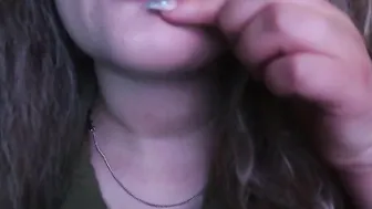 ADORABLE WOMAN PAINTS HER LIPS RED AND SMOKES a CIGARETTE
